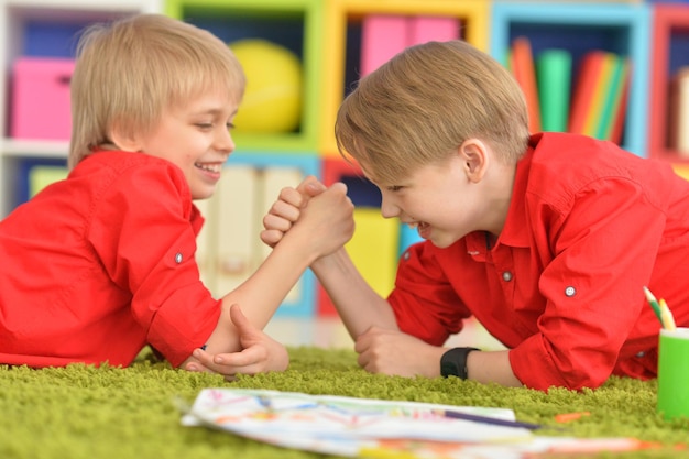 Portrait of two cute brothers draws with pencils