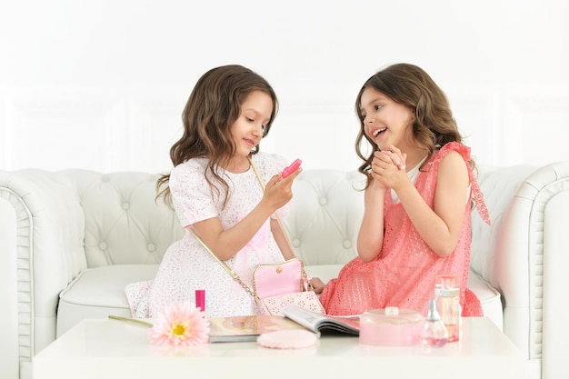 Portrait of two cute little girls playing together