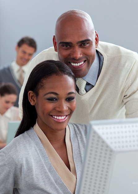 Portrait of two enthusiastic businesspeople working at a computer