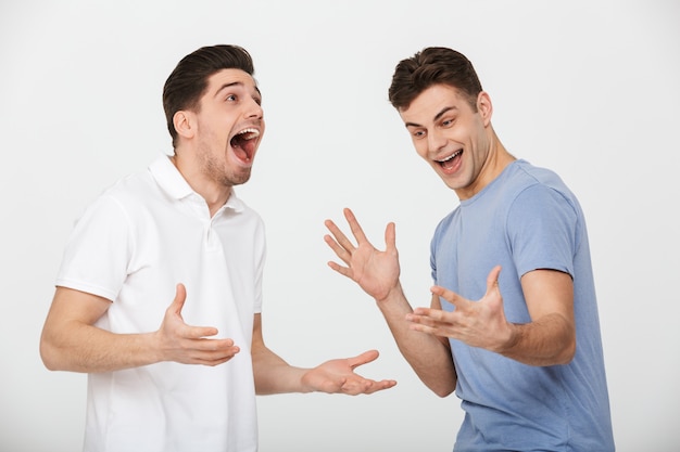 Portrait of two excited young men laughing