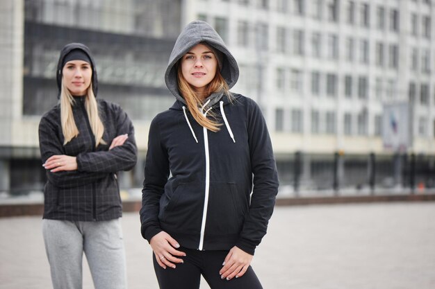 Portrait of two girls athletes in the street