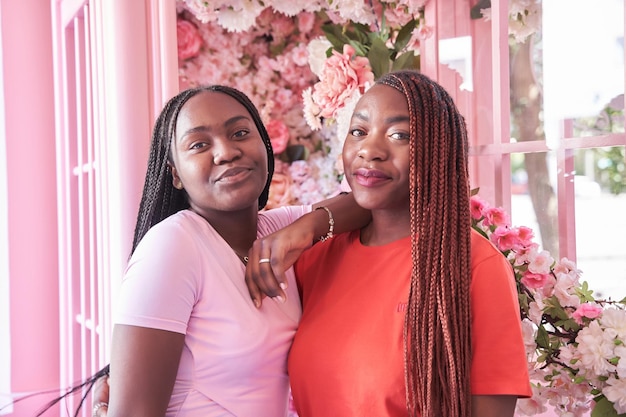 Portrait of two Guinean friends with braids