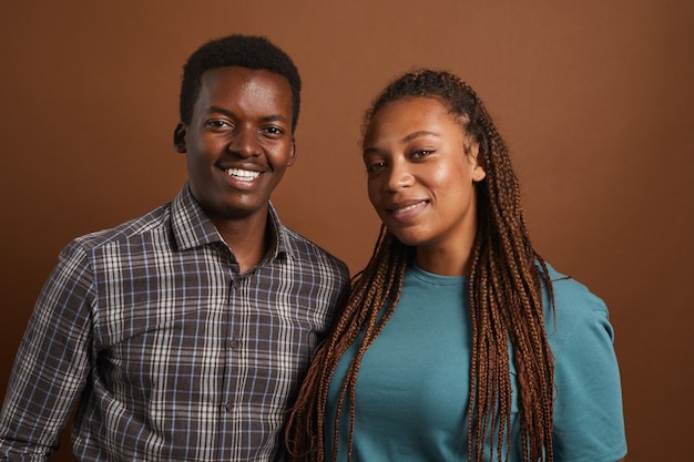 Portrait of two modern African-American people posing on brown