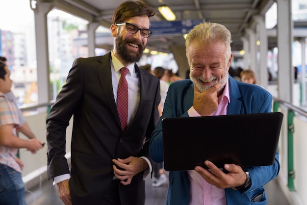 Portrait of two multi ethnic bearded businessmen together around the city of Bangkok