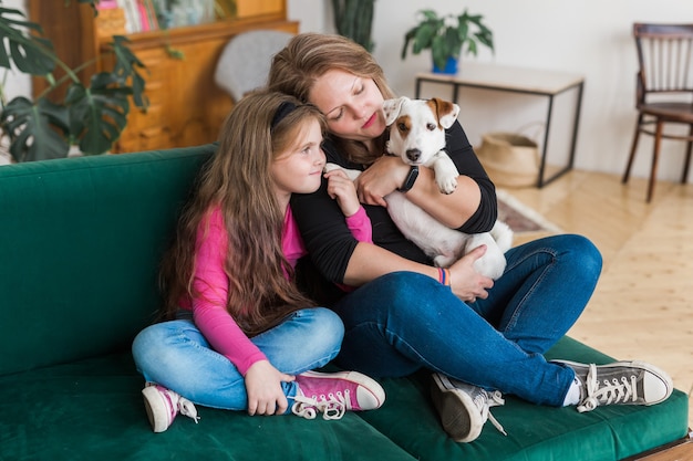 Portrait of two people lovely mom and her kid hug they are spend free time together sit comfy divan