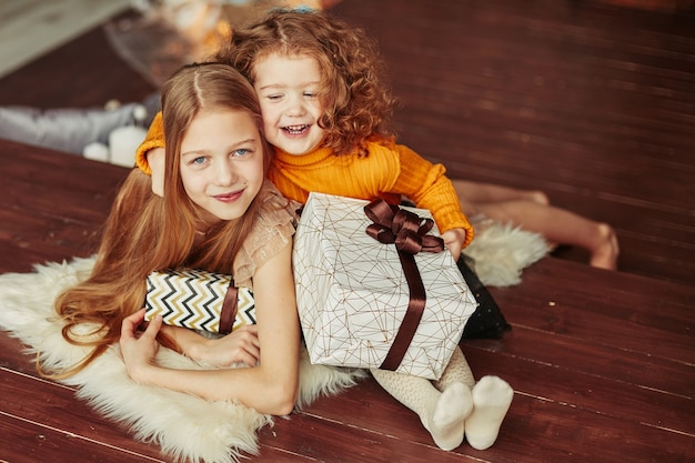 Portrait of two sisters on Christmas eve . the concept of Christmas