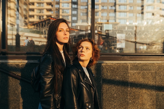 Portrait two stylish girlfriends in casual clothes