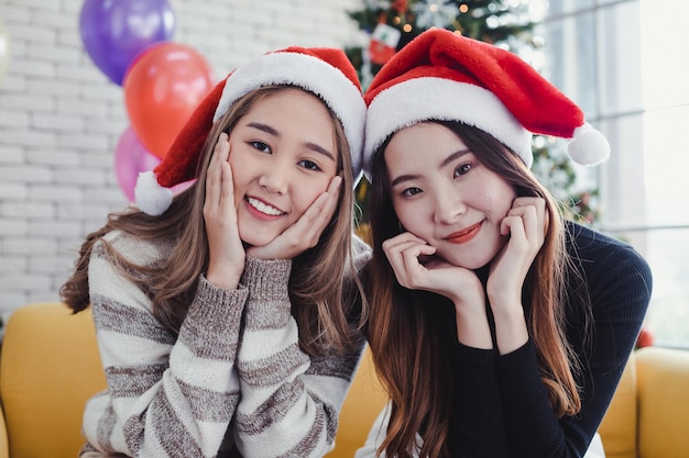 Portrait of two young Asian women dressing up for theme Christmas at home in celebrate Christmas festival together in happy holidays. Two lovely Thai girls in celebrate Christmas and new year concept.