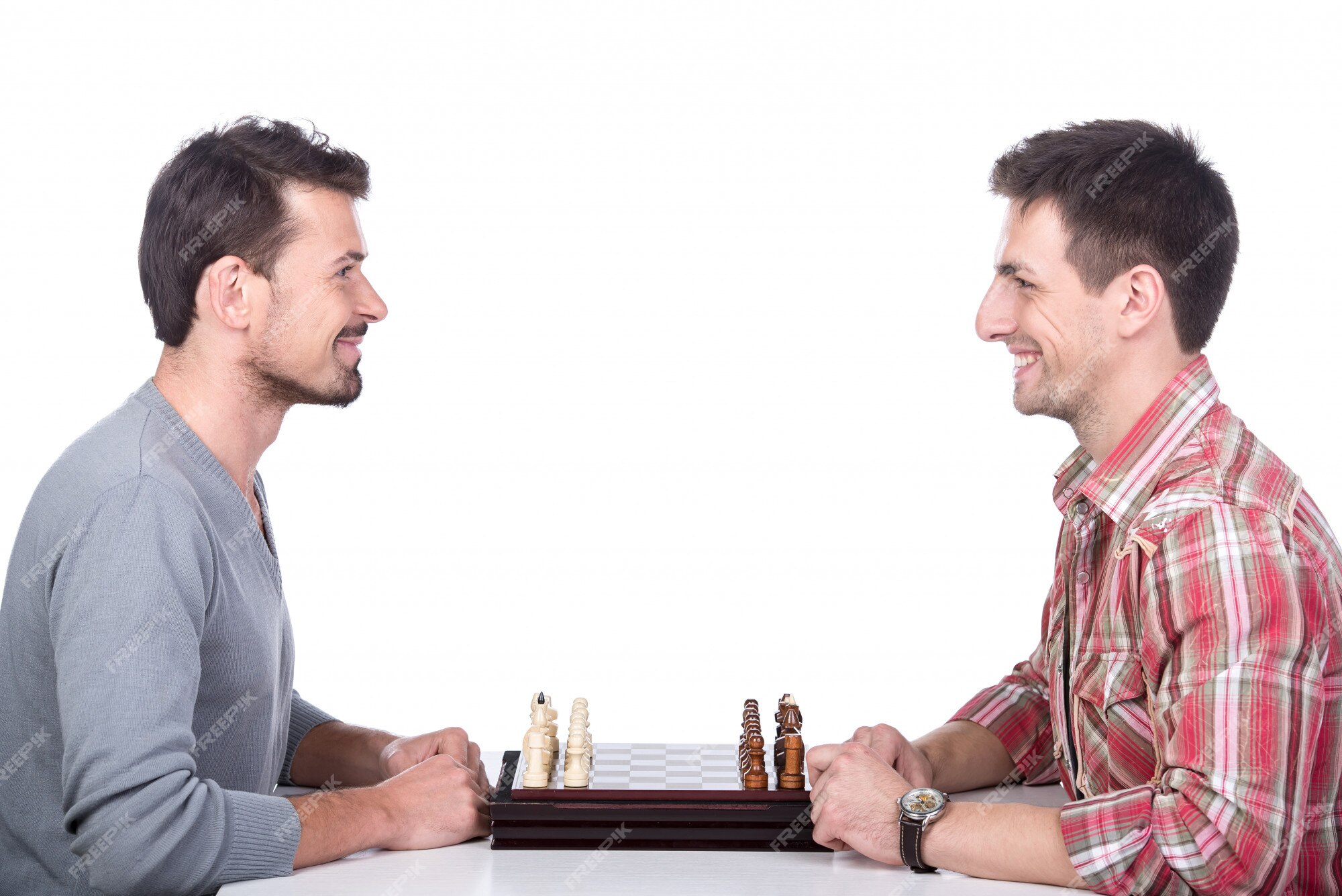 Premium Photo  Two young man are playing chess