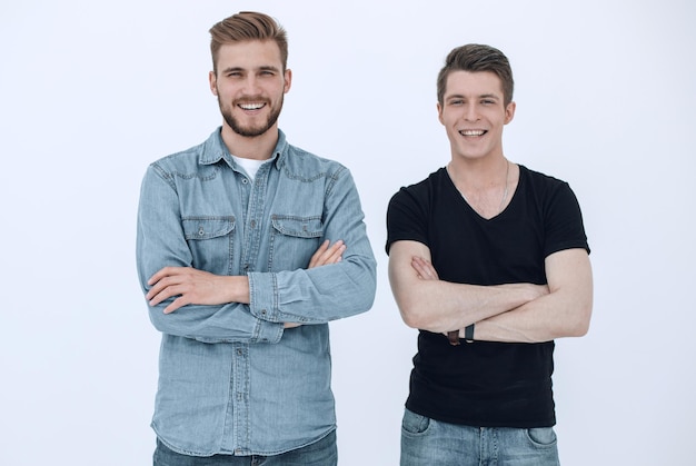 Portrait Of Two Young Men With Arms Crossed Isolated On White Background