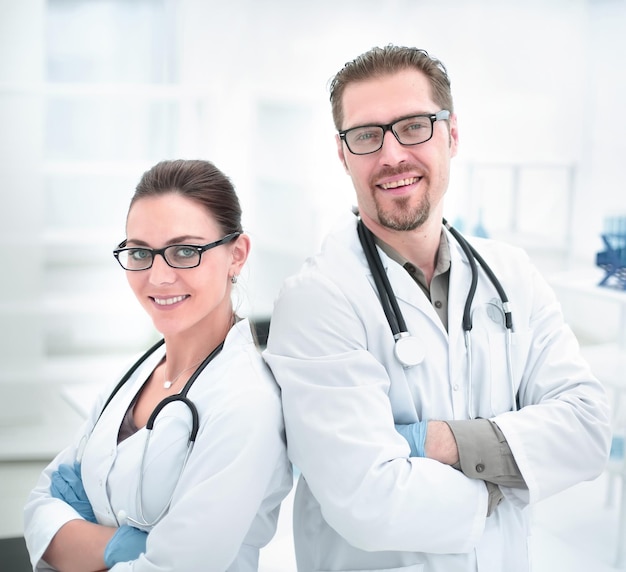 Portrait of two young scientists on the background of the laboratory