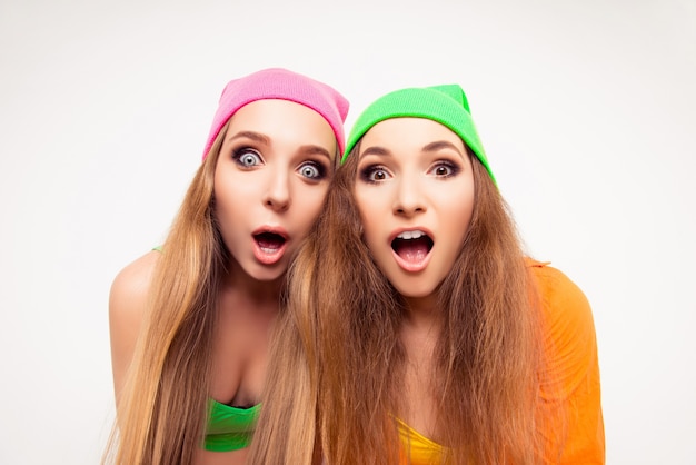 Portrait of two young shocked women with open mouth