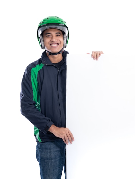 Portrait of uber rider with helmet holding blank white board