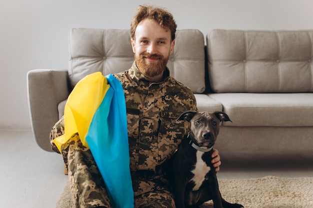 Portrait of a Ukrainian soldier and his faithful friend the Amstaff dog at the office