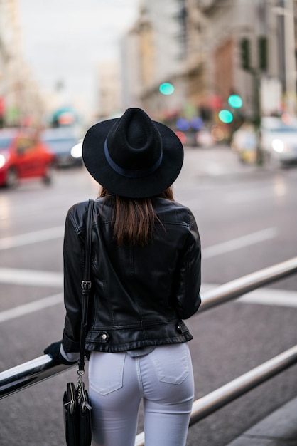 Portrait of an unrecognizable young caucasian woman with a hat