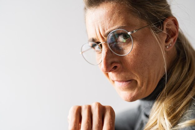 Portrait of an upset angry and unhappy casual women look over the shoulder face expression emotion reaction