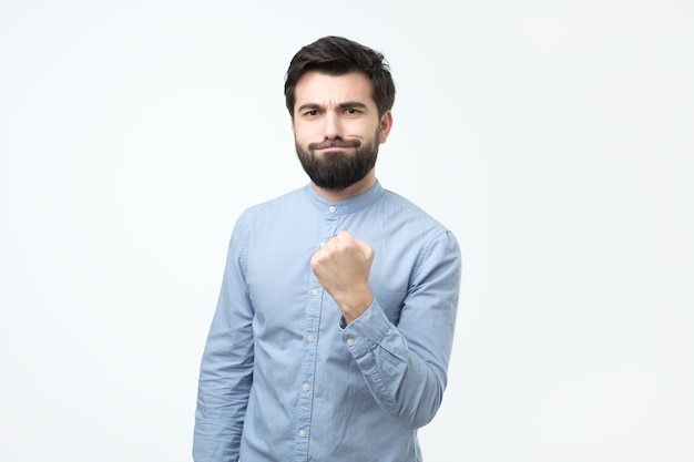 Portrait of very excited young man celebrating victory with raised fist I have done it