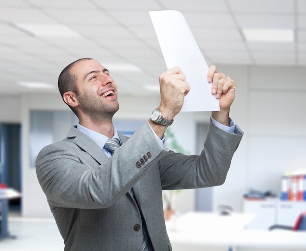 Portrait of a very happy business man holding a document