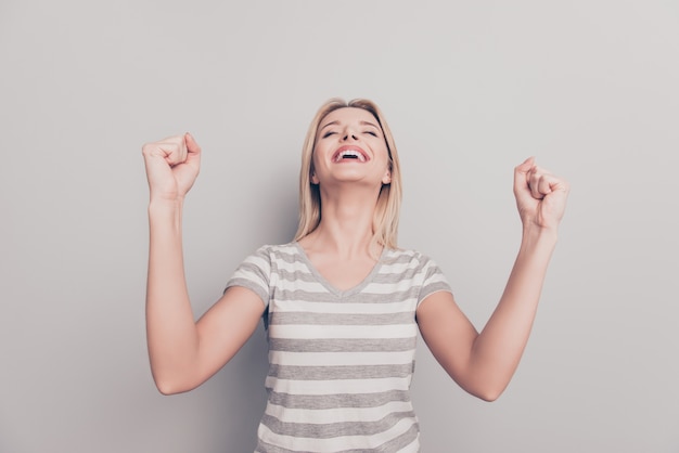 Portrait of victorious attractive blonde woman