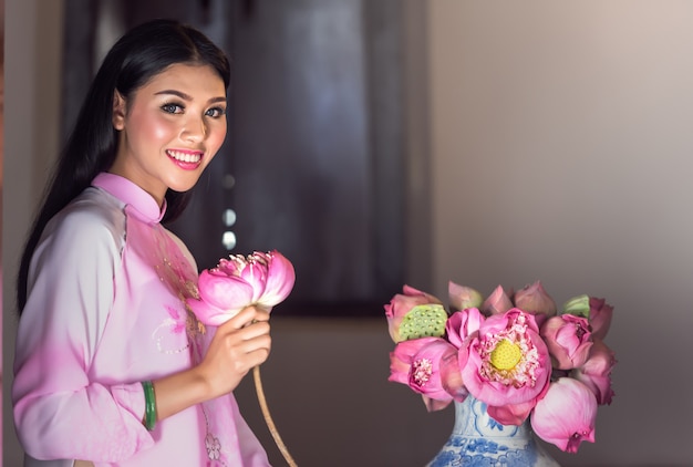 Portrait of Vietnamese girl traditional dress with lotus