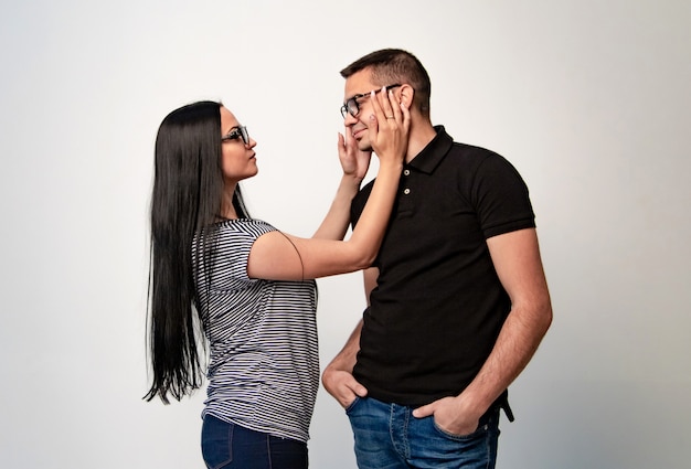 Portrait view of beautiful couple in eyeglasses looking at each other with love