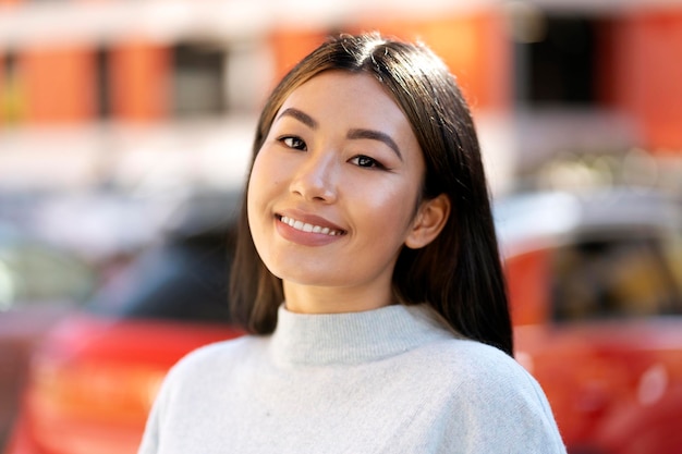 Portrait view of cheerful university student smiling toothy while posing at the street