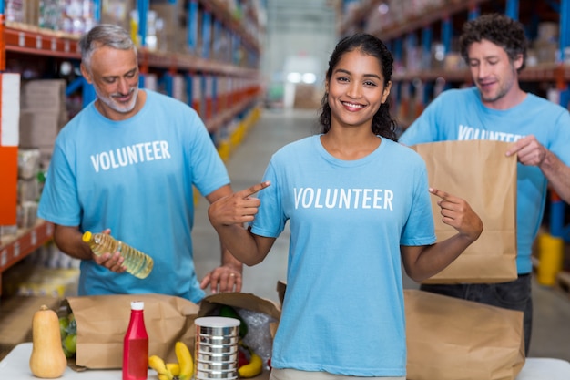 Portrait of volunteer pointing at t-shirt