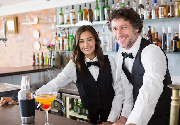 Portrait of waiter and waitress smiling