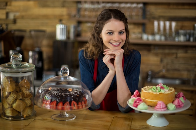 Portrait of waitress standing behind the counter