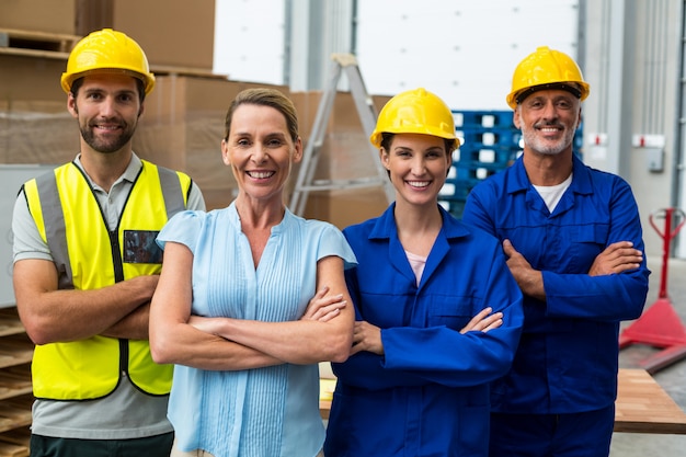 Portrait of warehouse manager and worker standing together with arms crossed