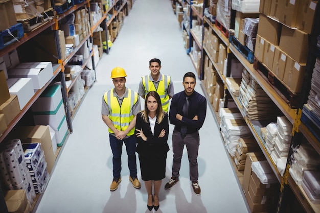 Portrait of warehouse manager and workers in warehouse