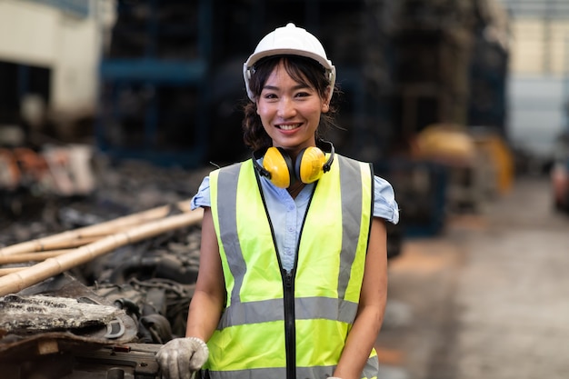 Portrait warehouse managers or worker asian woman working  at large distribution warehouse of old car part.