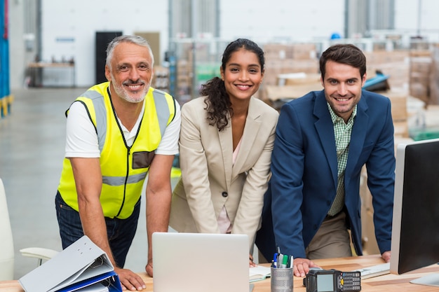 Portrait of warehouse managers and worker working together