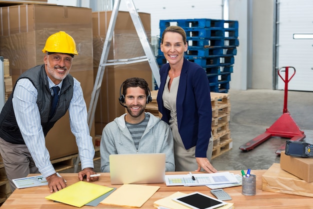 Portrait of warehouse managers and worker working together