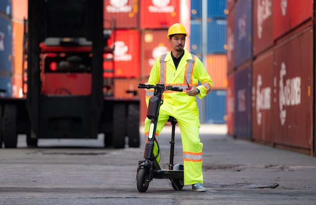 Portrait of a warehouse worker speaking on a walkie talkie with a coworker in an empty container