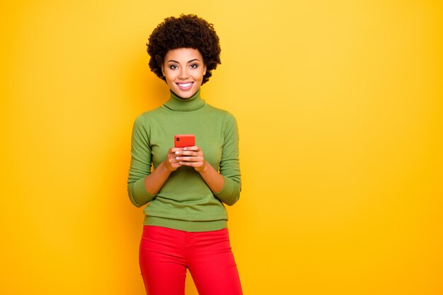 portrait of wavy cheerful positive cute pretty nice woman smile toothily in red trousers expressing emotions on charming face.