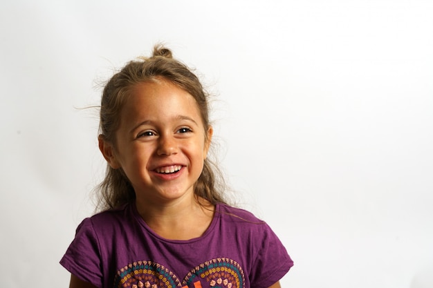 Portrait on white background of a 4 year old Italian girl looking sideways