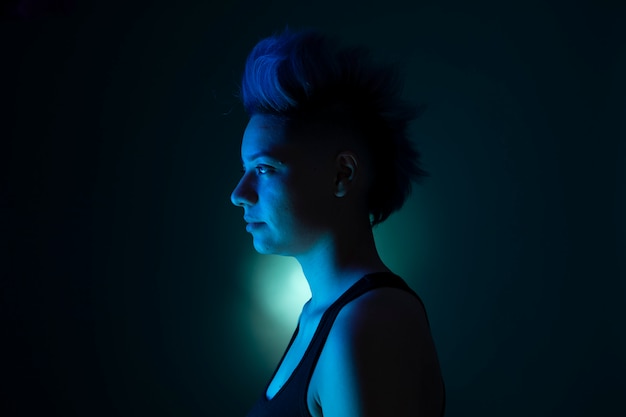 Portrait with artistic light of a woman with punk hairstyle.