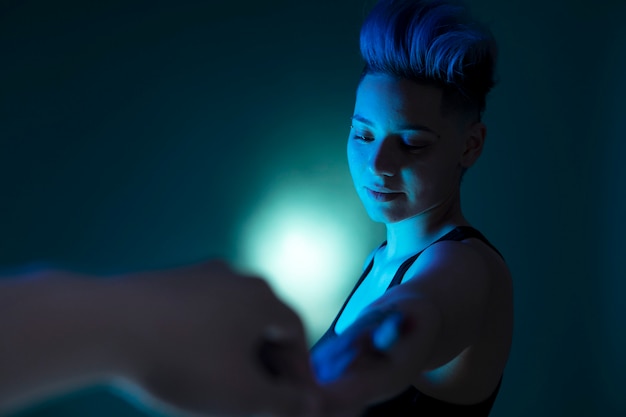 Portrait with artistic light of a woman with punk hairstyle.