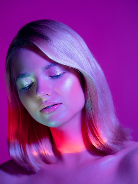 Portrait with neonstyle lighting a young beautiful blonde