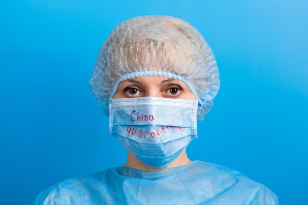 Photo portrait of woman against blue background in protection fase mask