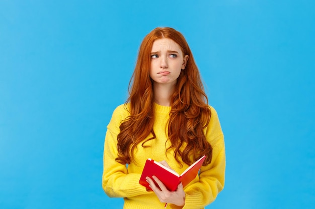 Portrait of woman against blue background