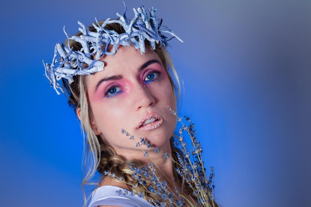 Portrait of woman against blue background