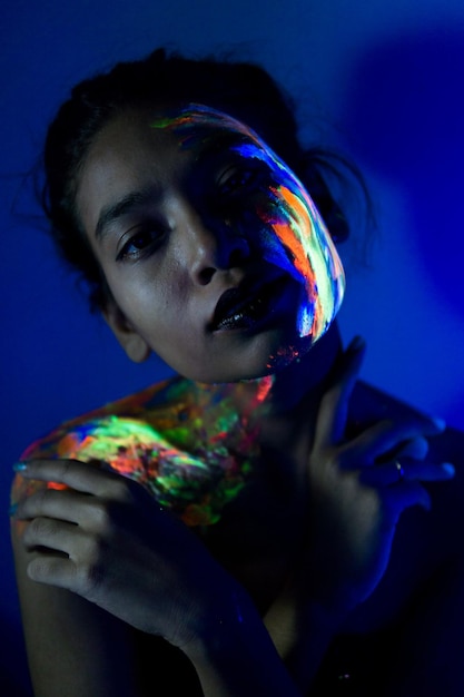 Portrait of woman against blue background