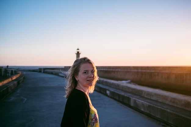 Portrait of woman against clear sky