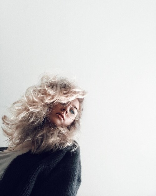 Photo portrait of woman against with blond hair over white background