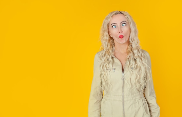 Portrait of woman against yellow background