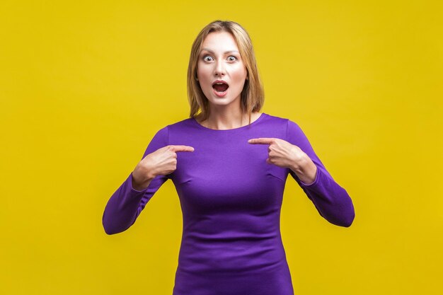 Portrait of woman against yellow background