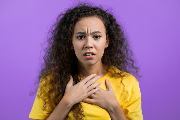 Portrait of woman against yellow background