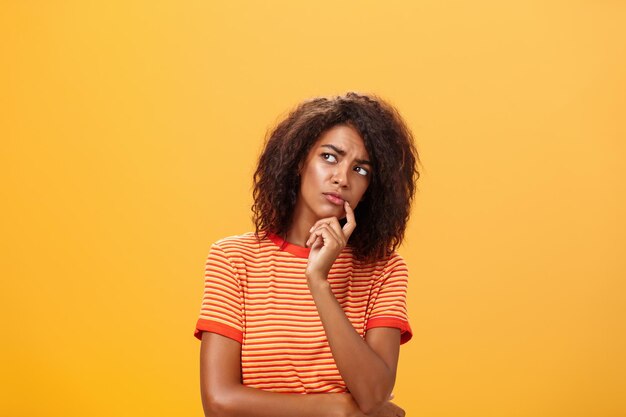 Portrait of woman against yellow background